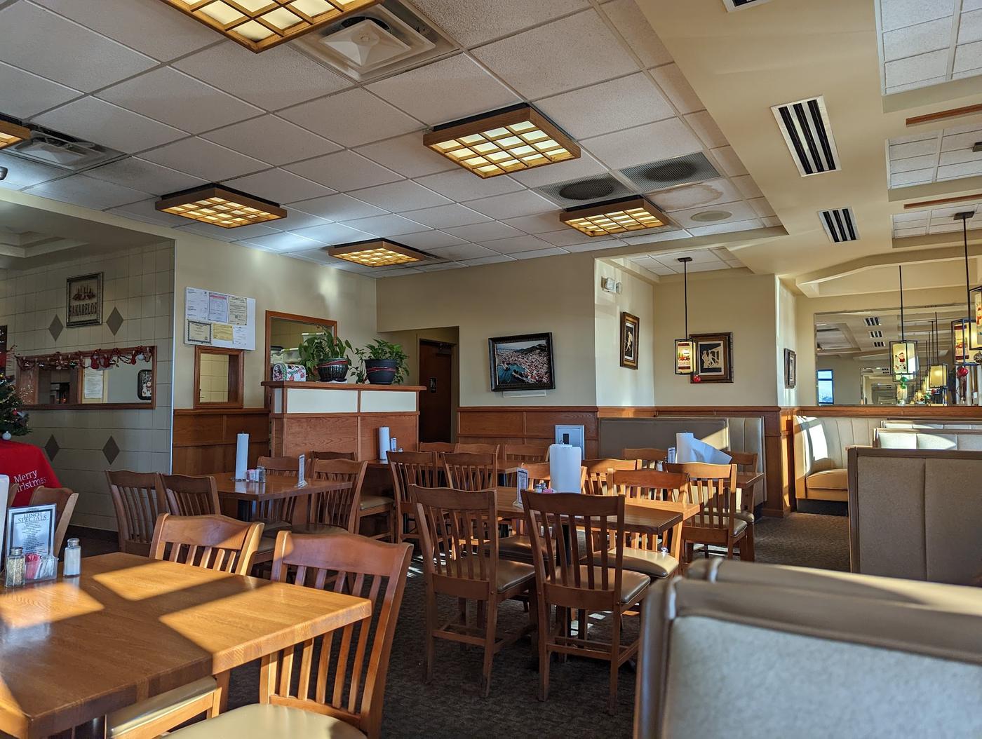 Booth and table seating in the dining room at Grecian Steak House