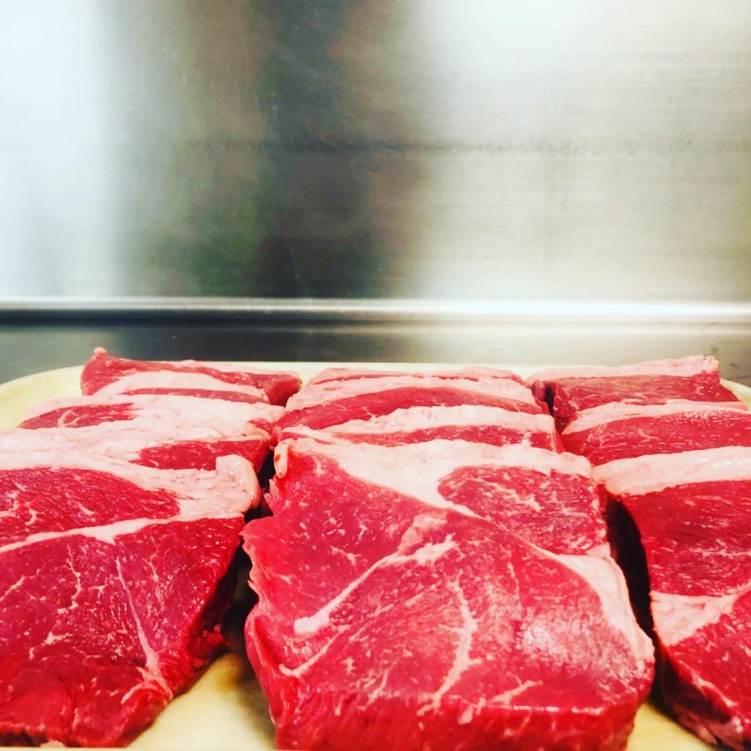 Hand cut ribeye steaks, ready for the grill at Grecian Steak House